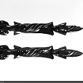 Elegant Carved Black Decorative Pieces Featuring Swirl Designs Floral Tops And Pointed Ends