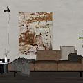 Brown Three-Seater Sofa with Gray Blanket Pillow Abstract Painting Floor Lamp and Green Plant