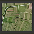 Aerial View Of Green Countryside Farmland With Historic Church And Lush Trees