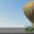 Floral Installation Featuring Yellow Hot Air Balloon with Flowers and Green Plants at Base