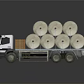 White Flatbed Truck Carrying Multiple Large Paper Rolls On Cargo Bed