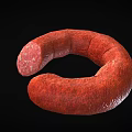 Red Curved Sausage With Sliced End Exposed Meat Texture On Black Background