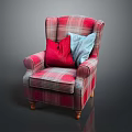 Plaid Upholstered Armchair With Red And Blue Pillows And Wooden Legs
