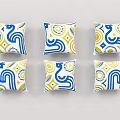 Six Decorative Pillows With Blue Yellow White Geometric Patterns Arranged Neatly
