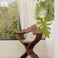Carved Wooden Dining Chair With Green Plants Near Window In Bright Indoor Space
