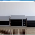 Modern Kitchen Appliances Including Microwave And Oven On Wooden Countertop