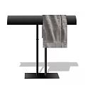 Black Coat Rack With Curved Top Two Upright Poles Square Base And Gray Towel Hanging
