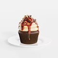 Delicious Cupcake Topped With Chocolate Drizzle Caramel Sauce And Chopped Nuts On White Plate