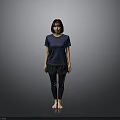 A Woman Standing Barefoot in Blue T-Shirt and Black Pants Against Gray Background