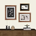 Botanical Paintings in Wooden Frames Hanging on Wall with Candles Vase and Books
