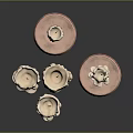 Three Candle Holders With Copper Bases And Burned Beige Candles Against Dark Background