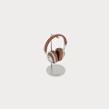 Brown Leather Headphones With Silver Metal Accents On Stand And Placed