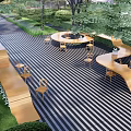 Tranquil Residential Landscape Featuring Striped Flooring Wooden Seating Circular Fire Pit And Lush Greenery