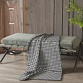 Padded Grey Ottoman Bench With Black And White Checkered Blanket And Metal Legs