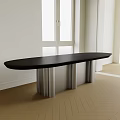 Modern Oval Black Dining Table With Silver Metal Legs And White Walls Wooden Floor