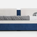 Upholstered Daybed In Blue And White With Gray Linen Throw And Decorative Pillows