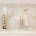 Minimalist Clothing Store Interior With Golden Racks Hanging Dresses White Walls And Display Shelves