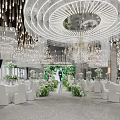 Elegant Banquet Hall With Chandeliers White Tables Green Floral Decorations And Central Flower Pathway