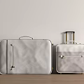Light Gray Leather Suitcases With Metal Accents On Wooden Floor Against Light Wall