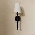 Modern Wall Sconce With White Fabric Shade And Black Metal Frame On Beige Wall