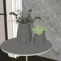Textured Silver Vases With Green Plants And Spherical Flowers On White Round Table