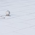 White Spherical Device With Orange Circular Light On Stone Floor And Black Cable