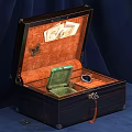Dark Wooden Display Cabinet with Orange Velvet Lining Green Box and Blue Gemstone Jewelry