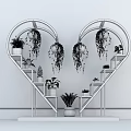 Heart Shaped Black And White Shelving Unit With Hanging Plants And Potted Greenery