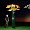 Orange Flower Shaped Structures On Green Grass With Blue Sky White Clouds And Man 3d model