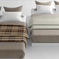 Double Bed With Plaid And Striped Bedspreads And Decorative Pillows In Neutral Tones