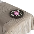 Comfortable Massage Bed With Soft Blanket Cozy Towels And Decorative Tray Of Pink Flowers