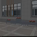 Modern Outdoor Garden Planters With Red Flowers Along Building Exterior On Paved Ground