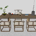 Natural Wooden Tea Table And Chairs With Tea Set Plant And Books In Cozy Interior