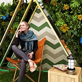 Mall Decorative Display Area With Green Plant Wall Triangular Frame White Flowers And Chair