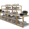 Modern Display Shelving With Gold Frame White Shelves And Tableware Cups Plates Bowls Vases Plants