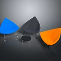 Vibrant Blue Gray Orange Single Chairs With Teardrop Shape And Metal Legs In Dark Background