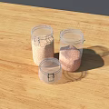 Three Clear Glass Jars With Granular Food Items Placed On Wooden Tabletop
