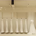 Bridal Wedding Dress Shop With Various Hanging Gowns And Elegant Interior Design
