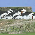 Traditional Style Buildings With White Walls Black Tiles On Hillside And Green Vegetation