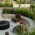 Outdoor Sofa With Fire Pit In Natural Garden Surrounded By Trees And Tall Grass
