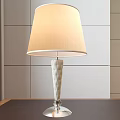 Elegant Table Lamp With Light Colored Fabric Lampshade And Tufted Glass Base On Wooden Table