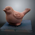 Detailed Terracotta Bird Sculpture Carving Standing On Blue Transparent Acrylic Base