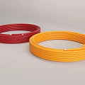 Red and Yellow Coiled Flexible Hoses on Gray Surface with Secure Fastening