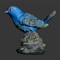Blue Bird Sculpture With Detailed Feathers Standing On Natural Stone Base