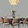 Elegant Dining Table Set With Round Black Tabletop Beige Chairs Flower Vase And Golden Decor