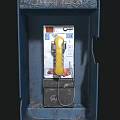 Vintage Public Telephone In Blue Booth With Yellow Handset And Keypad Stickers
