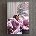 Portrait of Woman in Pink Fur Coat Sitting by Window on Sofa with Natural Light