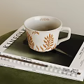 Elegant White Cup With Golden Leaf Designs On KINFOLK Lifestyle Magazine