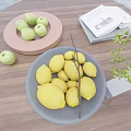 Ceramic Plates With Green Apples And Lemons On Wooden Tabletop With Magazine And Plant