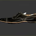Black Leather Brogue Dress Shoes With Intricate Perforated Design And Light Colored Sole